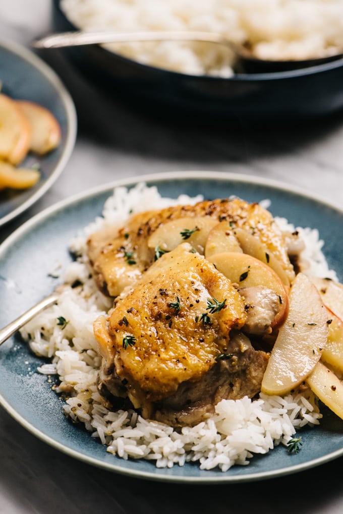 Side view, apple chicken over rice with cider sauce and sautéed apples.