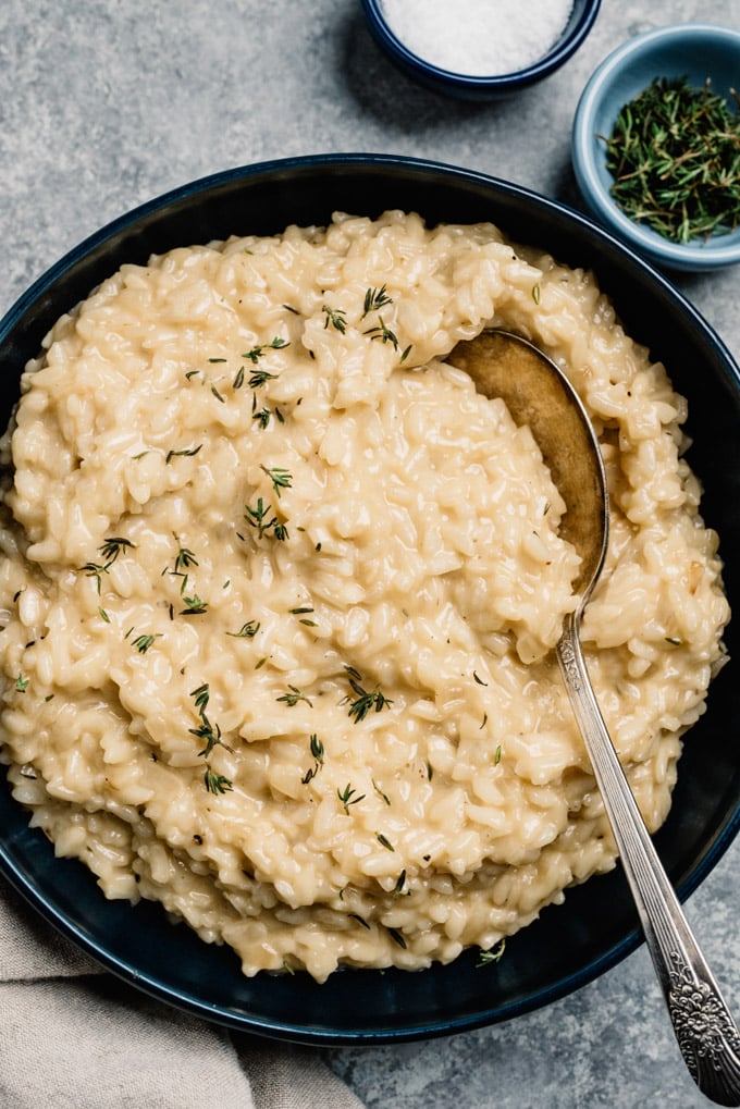 A serving bowl filled with risotto made in the instant pot.