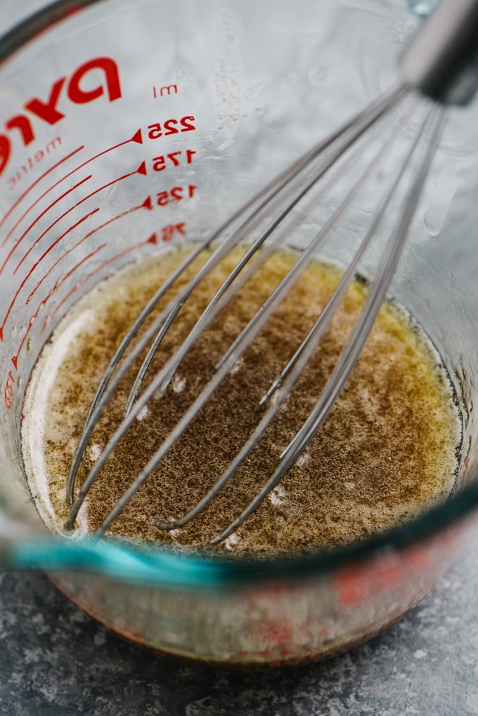 Maple brown butter in a glass measuring cup.