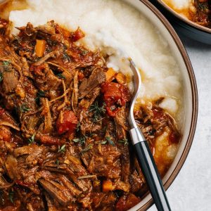 A bowl of Whole30 Instant Pot Beef Ragu served over mashed cauliflower.