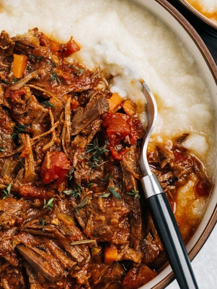 A bowl of Whole30 Instant Pot Beef Ragu served over mashed cauliflower.