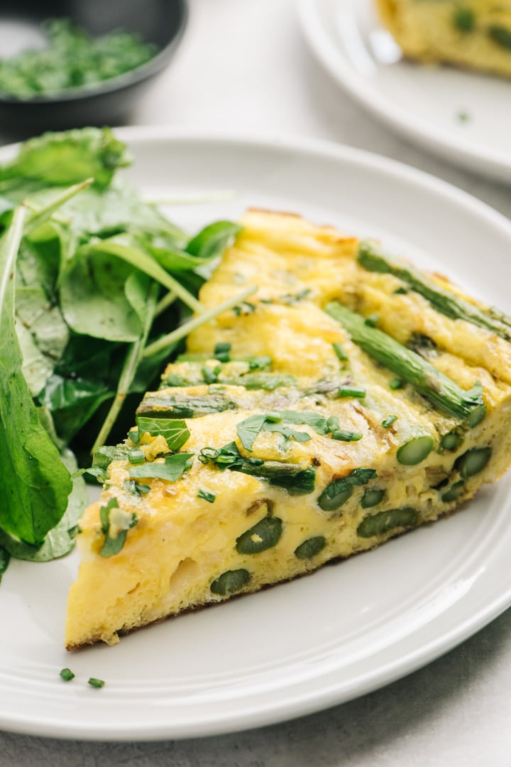 A slice of the frittata showing the asparagus stalks