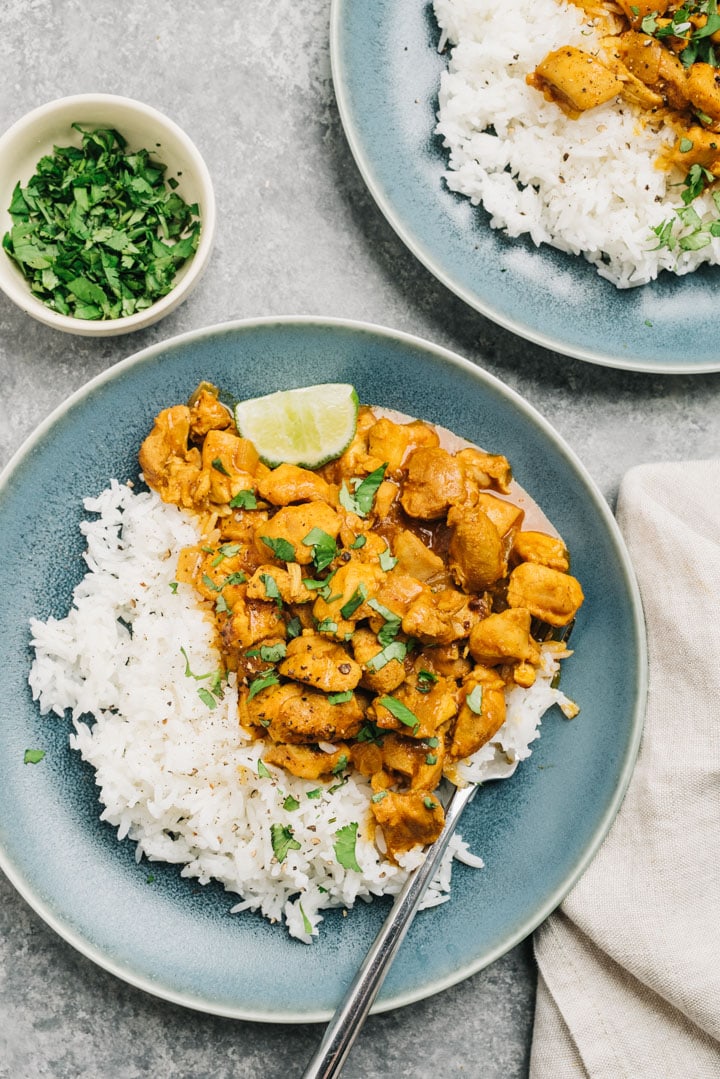 Instant Pot chicken curry served on two plates with rice