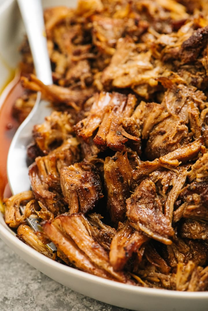 A serving bowl filled with Whole30 instant pot pulled pork.