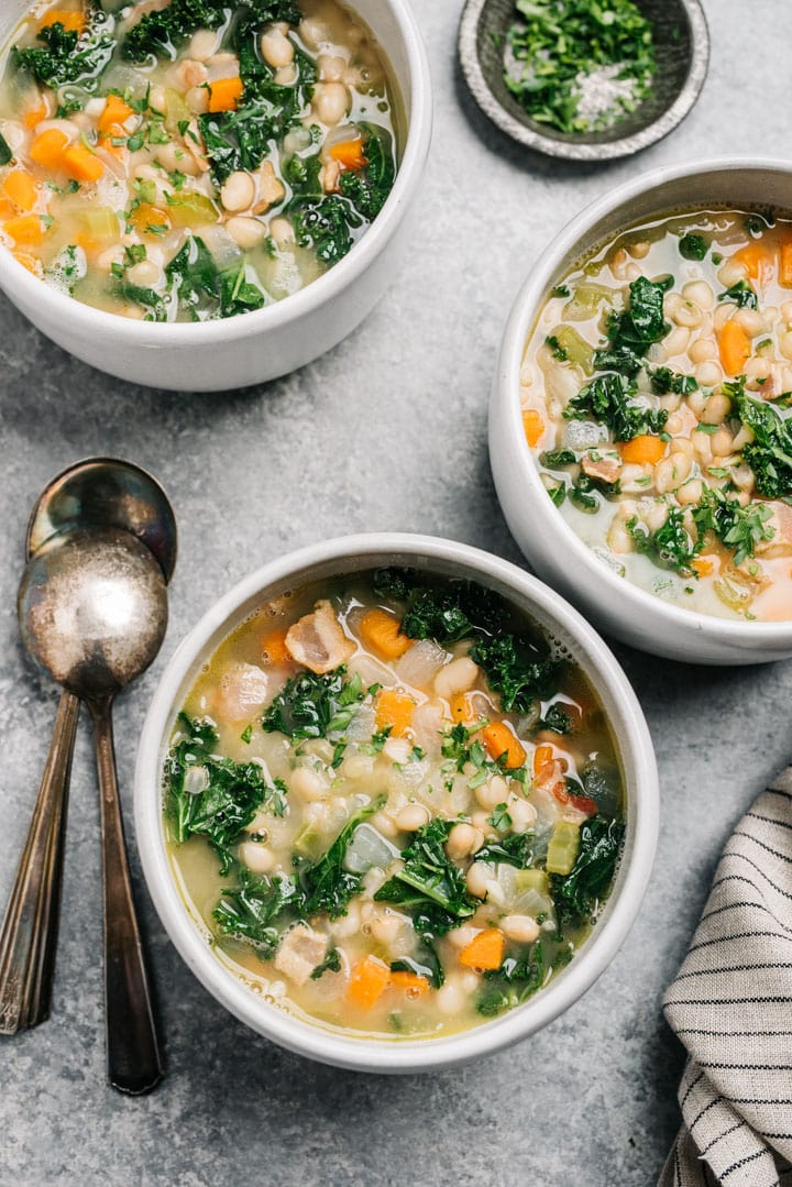 Three bowls of white bean and kale soup