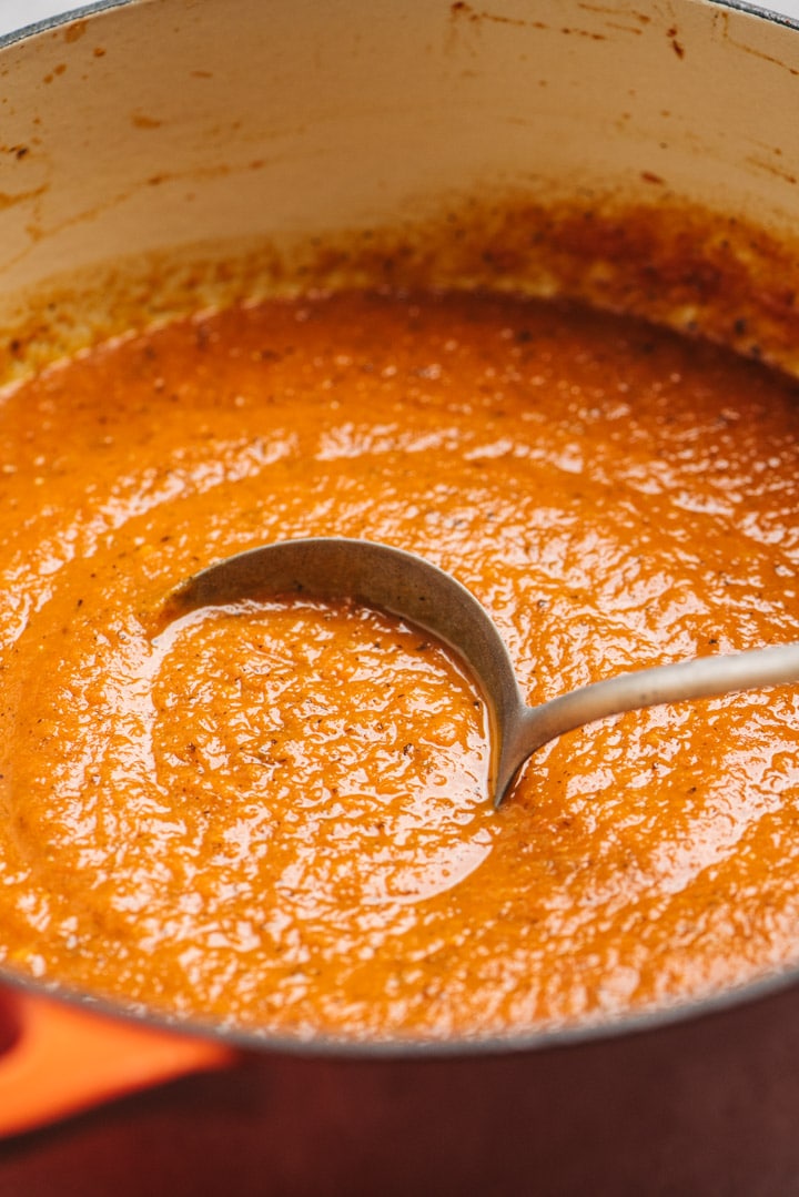 Marinara sauce in a pot with a ladle