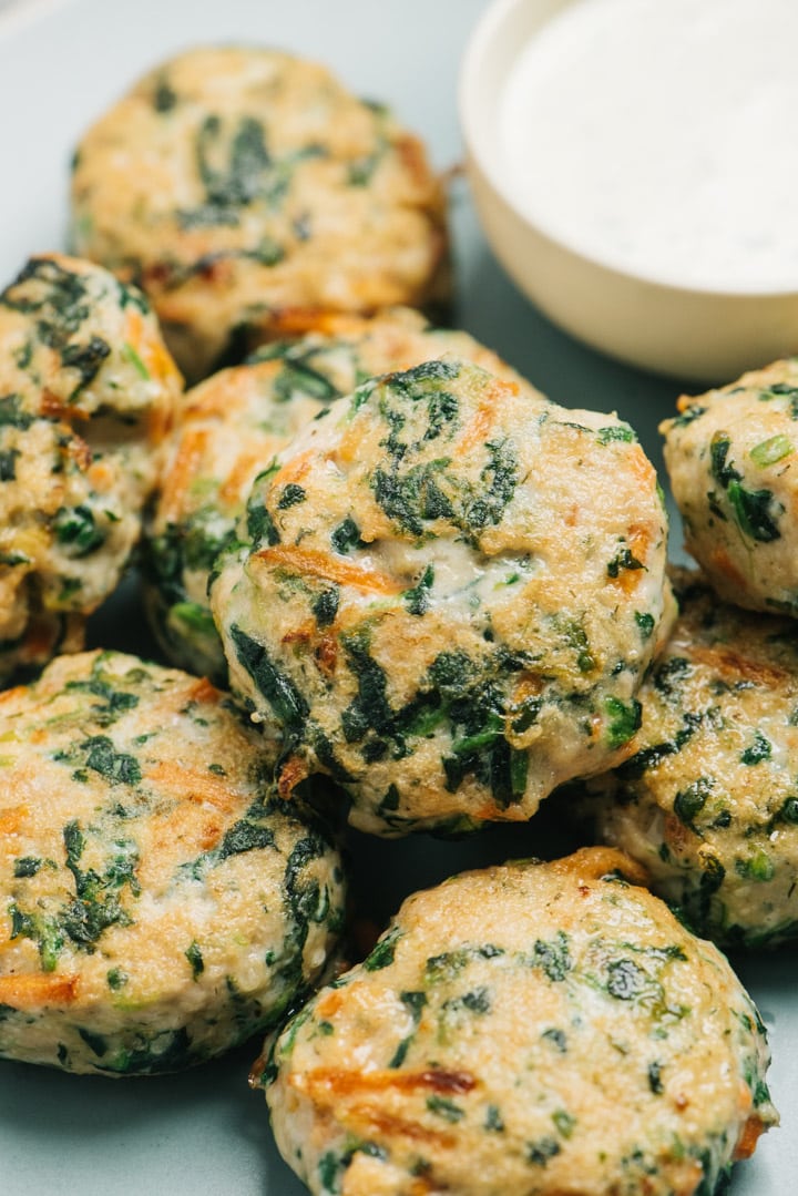 Ranch chicken meatballs with spinach and carrots on a plate.