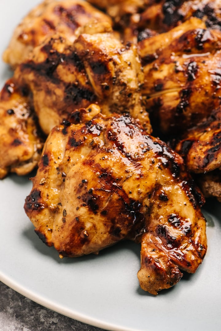 Side view of a grilled boneless skinless chicken thigh marinated in balsamic then grilled.
