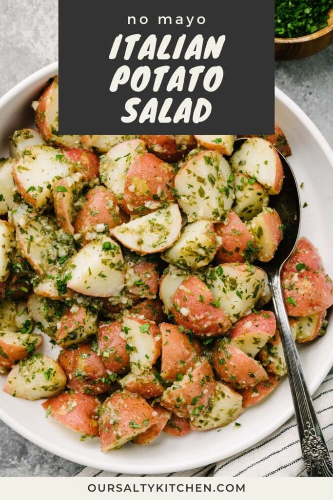 Baby red potatoes tossed with an herb vinaigrette in a large white mixing bowl with a linen napkin and bowl of fresh herbs to the side; title bar at the top reads "no mayo Italian potato salad".