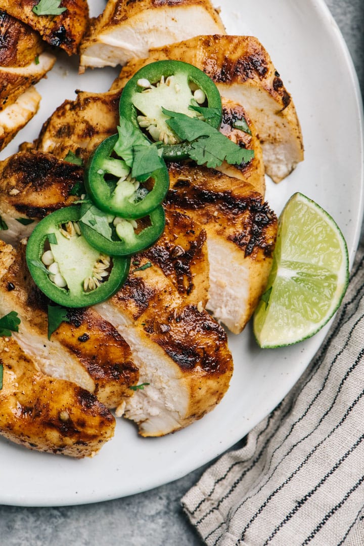 Overhead, slices of grilled chicken marinate and basted with chili lime marinade.