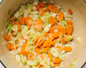 Sauted carrots, onions, and celery in a dutch oven.