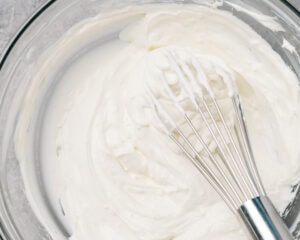 Cream cheese, greek yogurt, and sour cream whisked in a large mixing bowl.