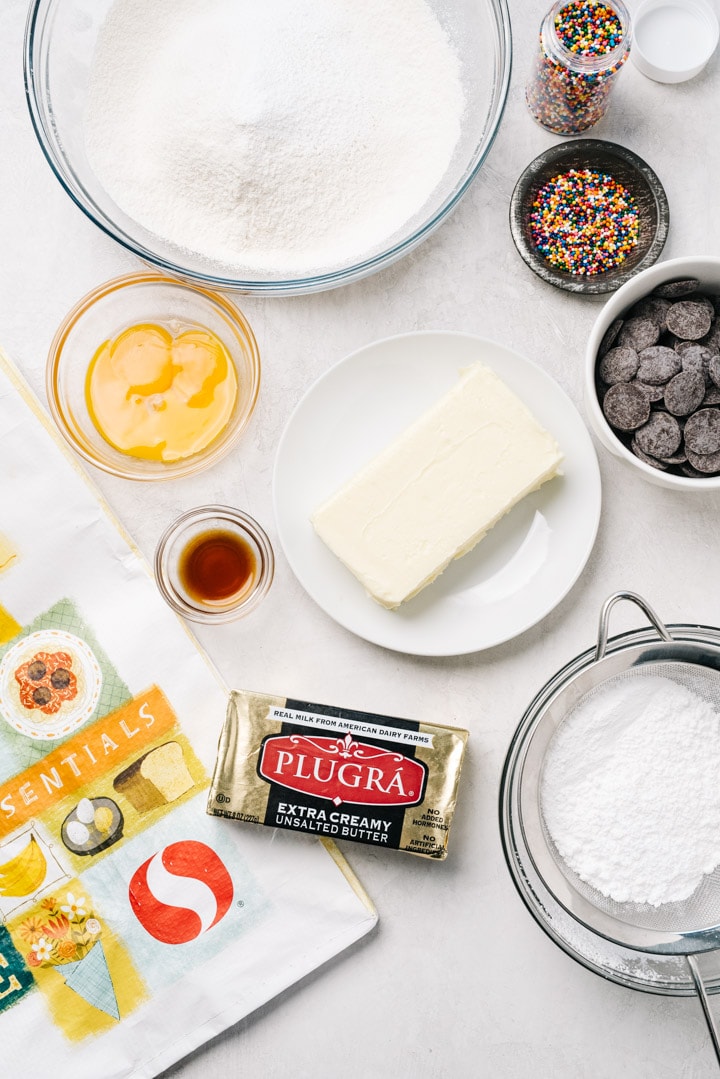 The ingredients for Italian butter cookies arranged on a cement background. 