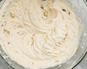 Cream cheese and brown sugar creamed in a mixing bowl.