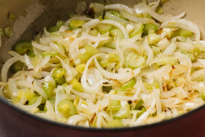Onion, leek, and celery sautéed in a red dutch oven.