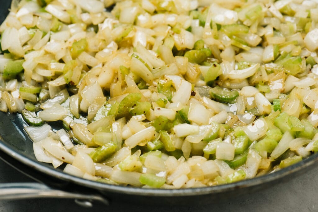 Sautéed onion and celery in a skillet with butter.