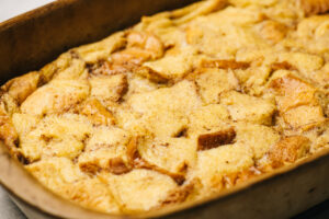 Baked french toast casserole fresh from the oven in a 9x13 casserole dish.