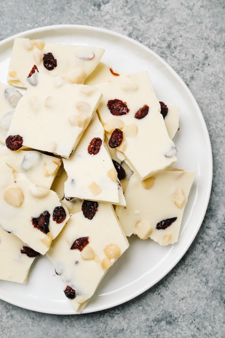 Pieces of white chocolate bark on a white plate. 