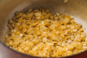 Finely diced onions and minced garlic sauteed until soft in a dutch oven soup pot.