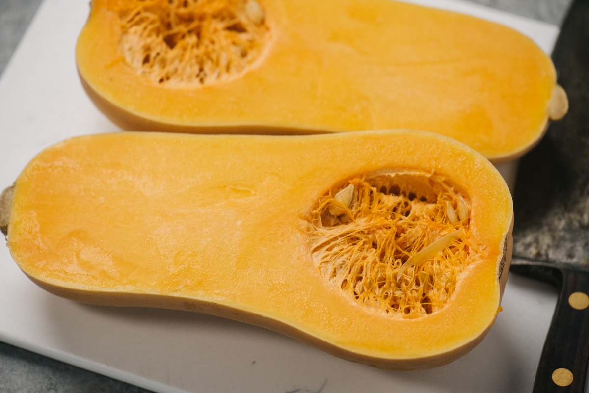 A butternut squash sliced in half lengthwise.
