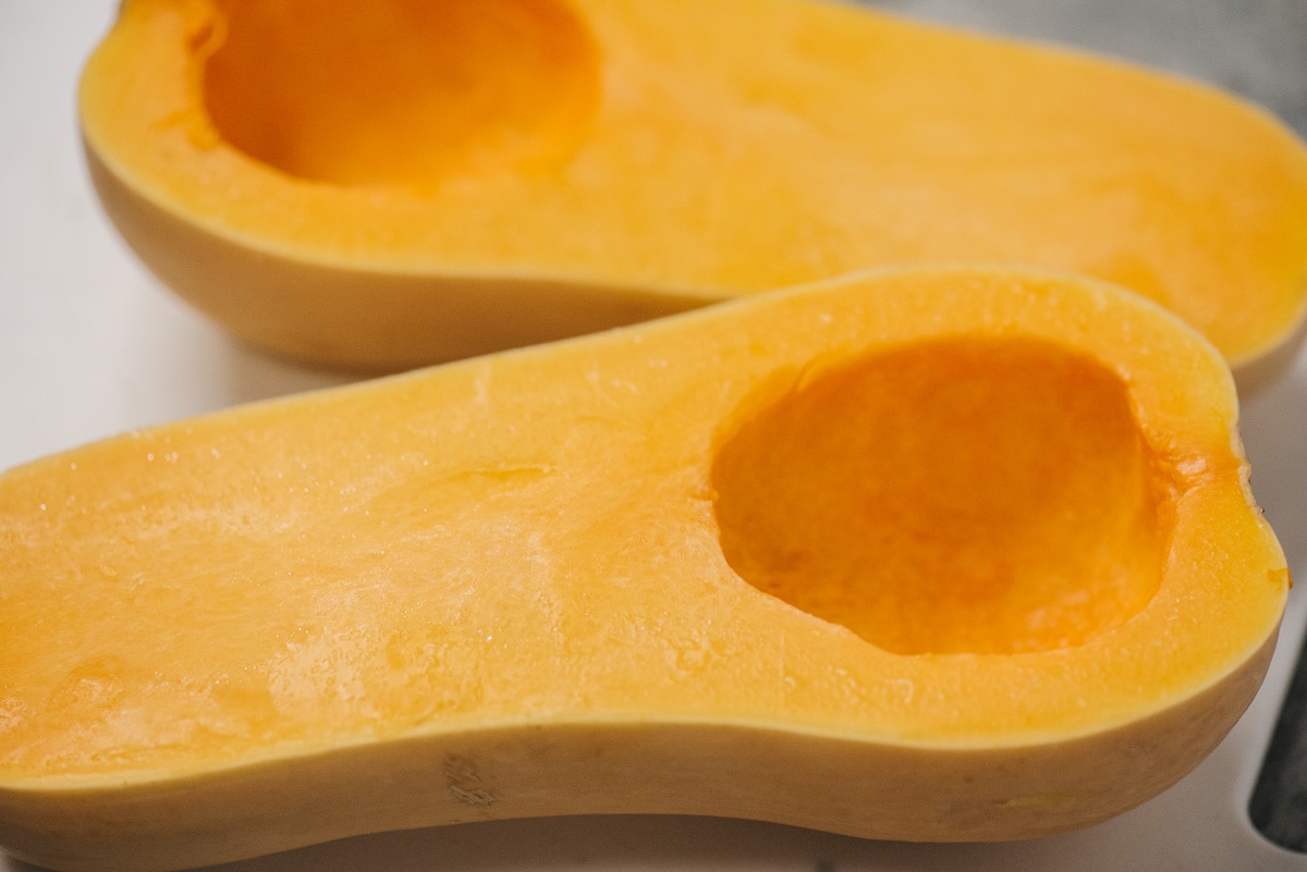 A butternut squash sliced in half with seeds removed.