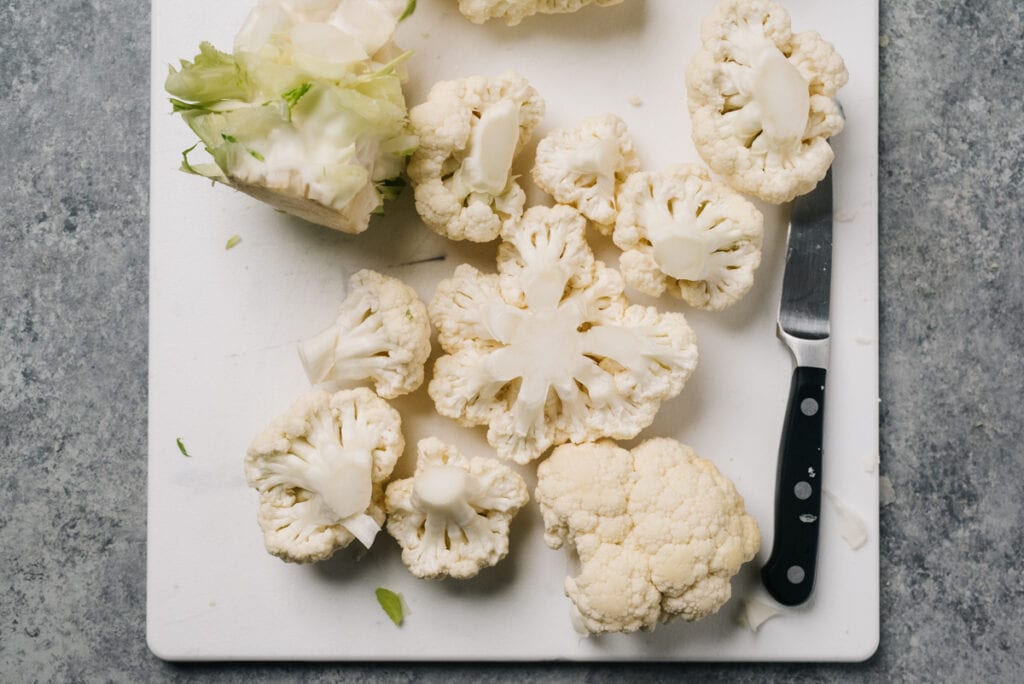 Cauliflower florets on a cutting board before trimming to size.
