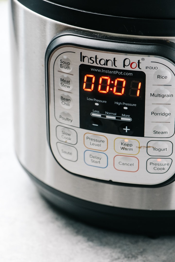 An instant pot programed to 1 minute on high pressure.