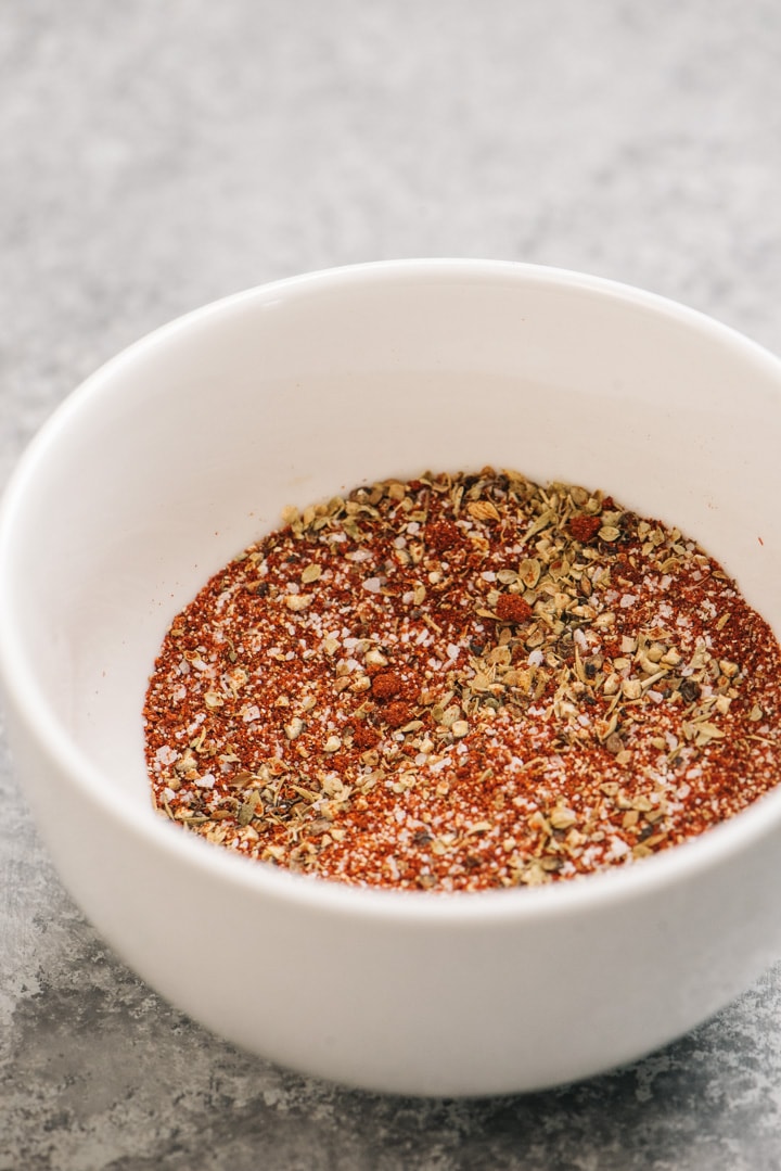 The dry rub seasonings for pulled pork mixed in a small white bowl.