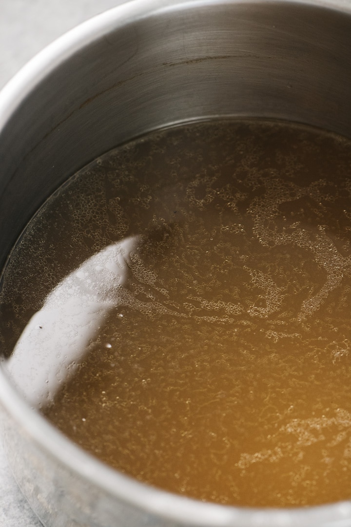 Filtered chicken bone broth in the inner pot of an instant pot.