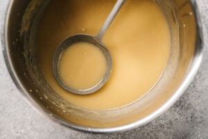 Stovetop chicken gravy in a 2-quart saucepot with a metal ladle.