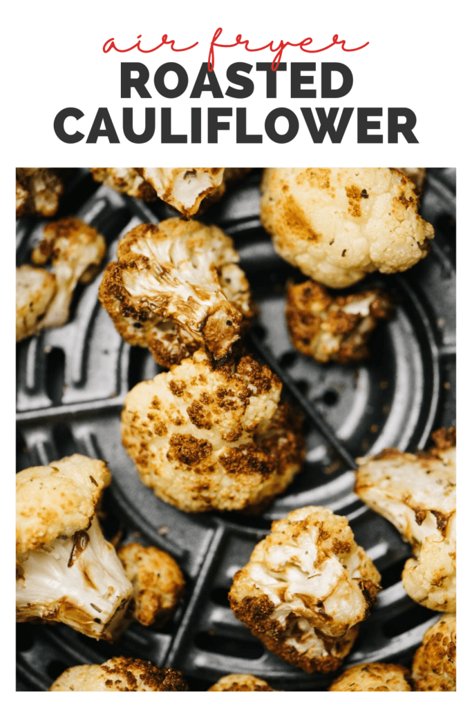 Close up view of air fried cauliflower florets in an air fryer basket with a title bar that reads "air fryer roasted cauliflower".