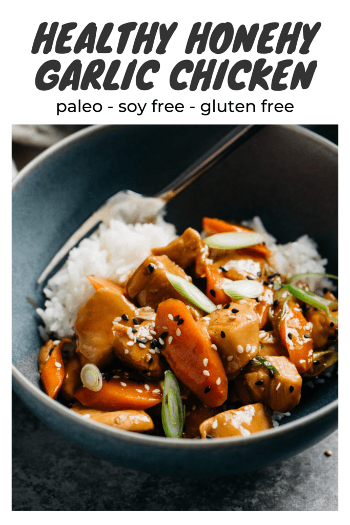 Side view, honey garlic chicken stir fry in a blue bowl served over white rice with silver fork with a title bar that reads "healthy honey garlic chicken - paleo, soy free, gluten free".