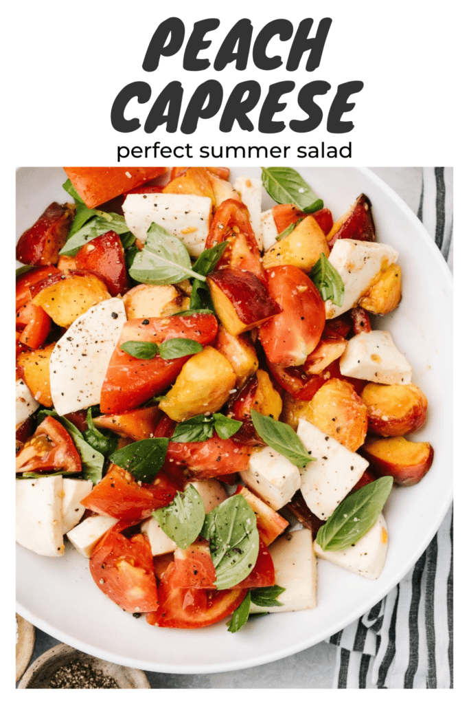 Diced peaches, diced tomatoes, fresh mozzarella, and basil tossed in a white serving bowl with a grey and white striped napkin with a title bar that reads "peach caprese - perfect summer salad".