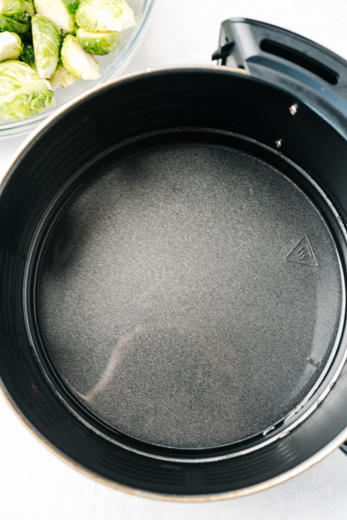 A small amount of water in the basket of an air fryer.
