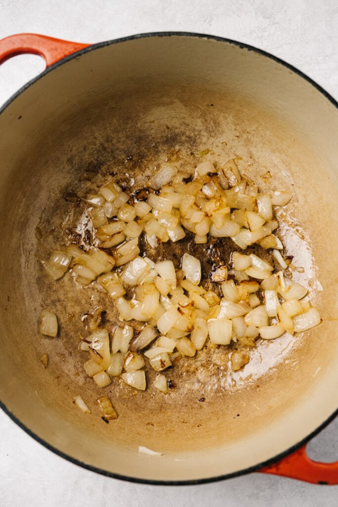 Sauteed diced onions in a dutch oven.