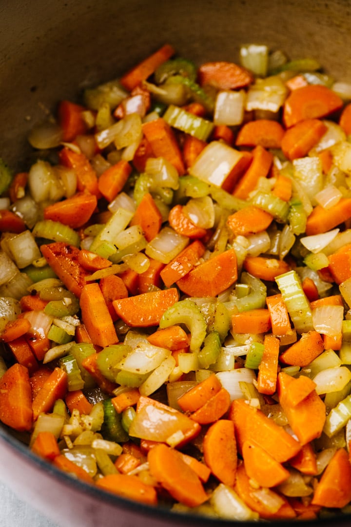 Sauteed onion, celery, and carrot with minced garlic in a dutch oven.