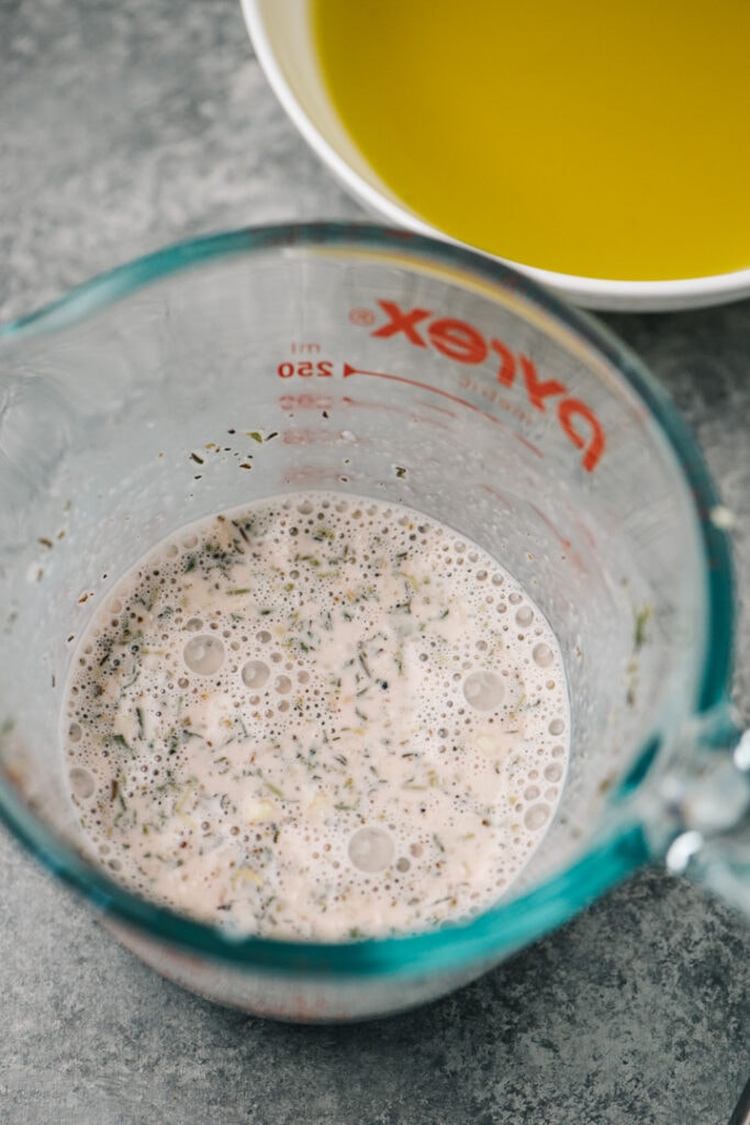 Mayonnaise, vinegar, mustard, and seasonings whisked until smooth in a pyrex measuring cup.
