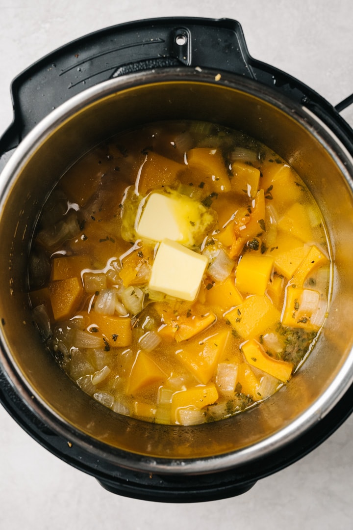 Adding butter to cooked instant pot butternut squash soup.