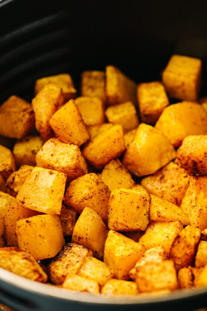 Side view, diced butternut squash after cooking in the air fryer for 20 minutes.