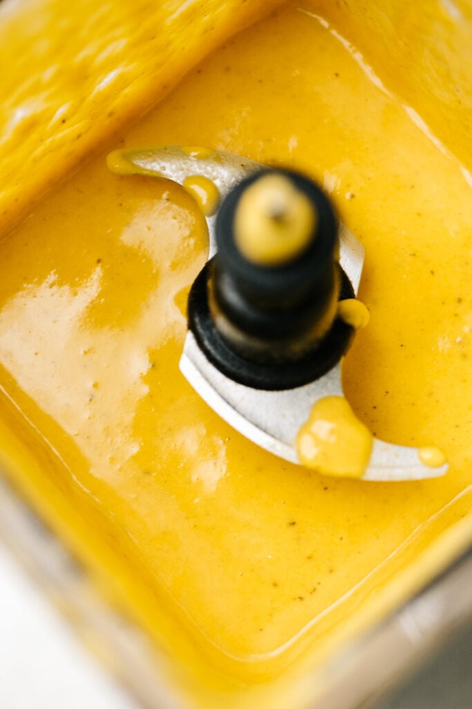 Creamy butternut squash cheese sauce in a blender.