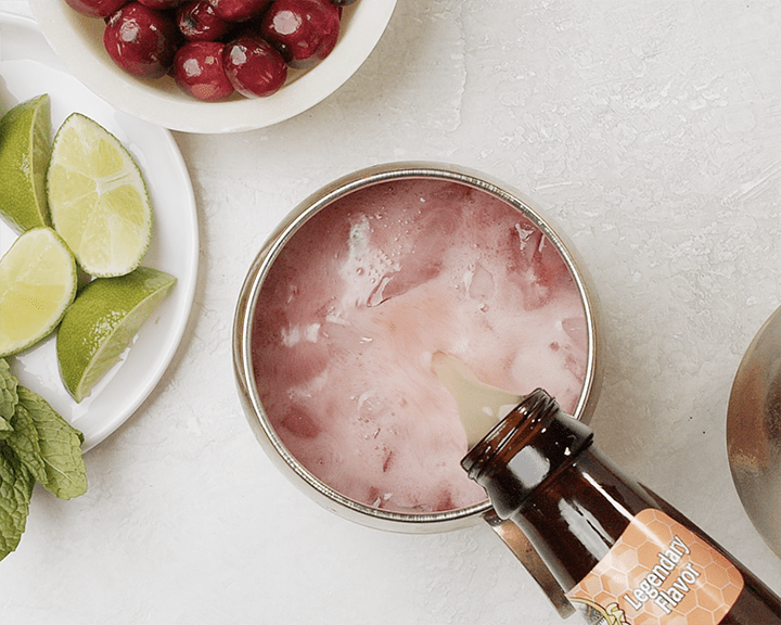 Topping the a cranberry moscow mule with ginger beer.