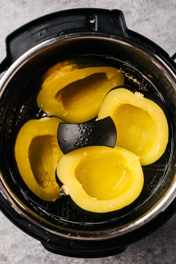 Steamed acorn squash halves in an instant pot.