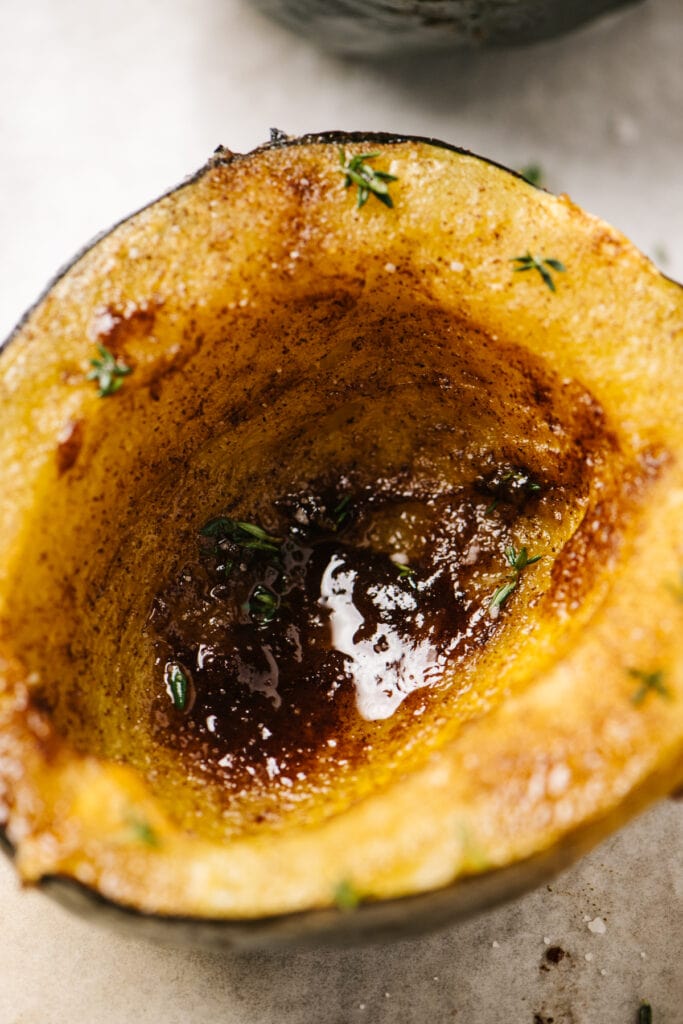 Side view, instant pot acorn squash halves with brown sugar and cinnamon.