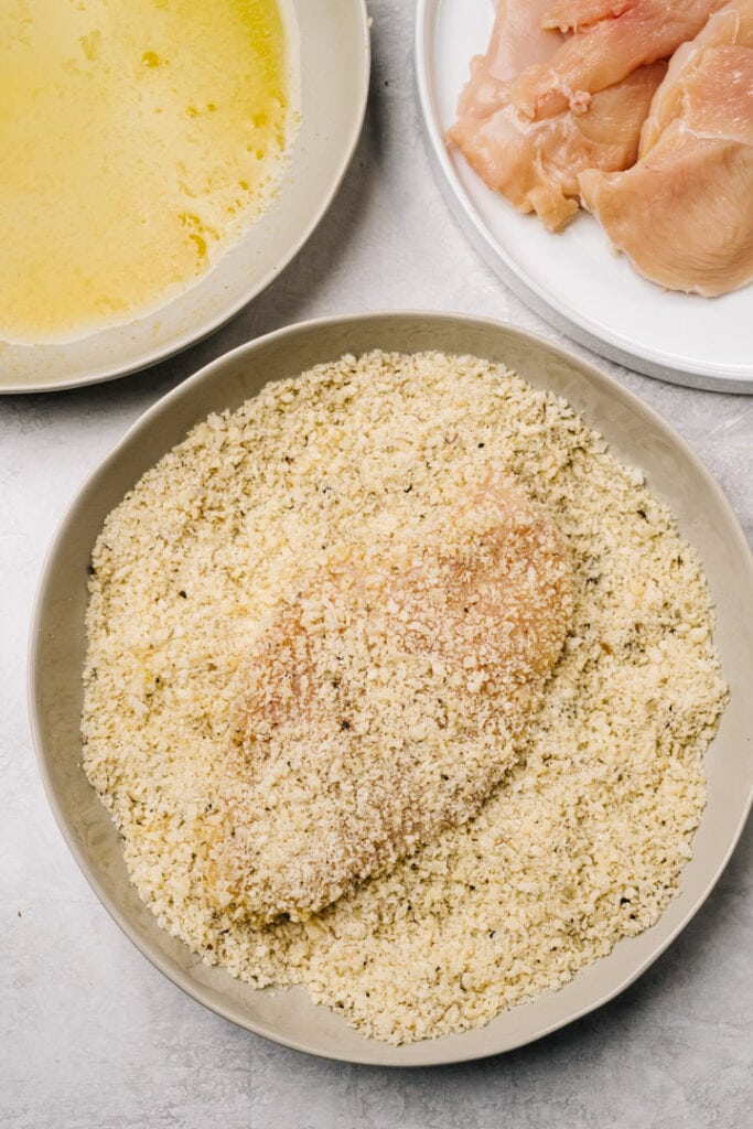 A thinly sliced chicken breast dipped into melted butter, then dipped into seasoned breadcrumbs to create a coating.