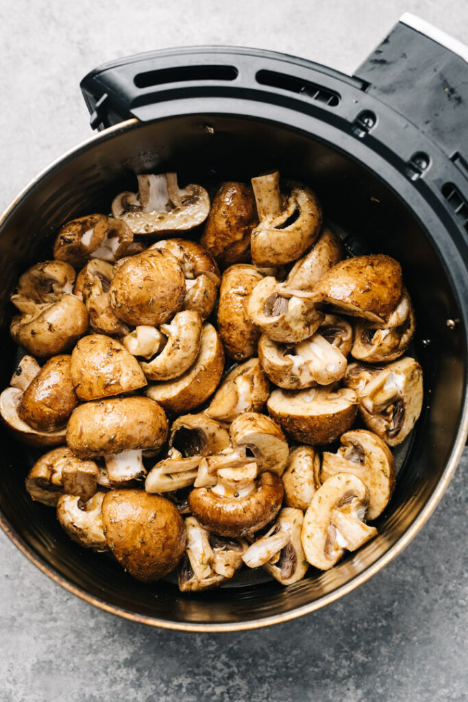 Quick marinated mushrooms in the basket of an air fryer.
