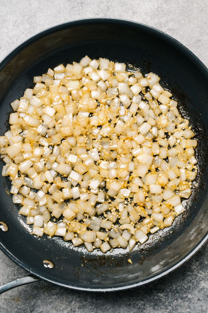 Diced onions and minced garlic sauteed in butter in a skillet.