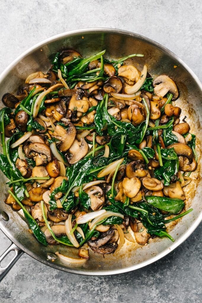 Sauteed mushrooms, onions, and spinach in a nonstick skilllet.