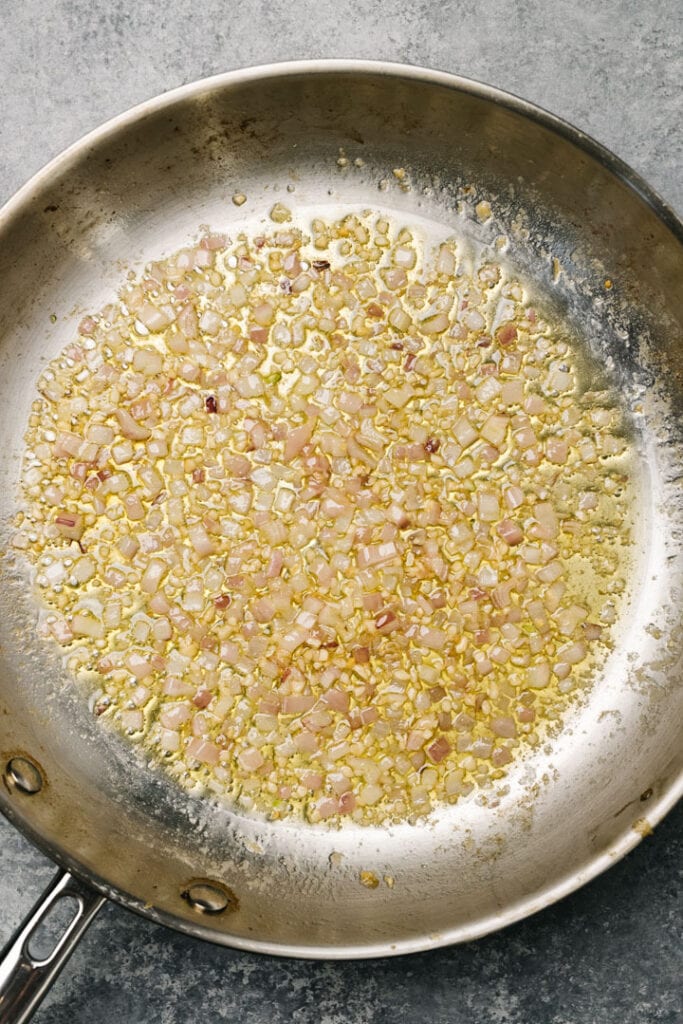 Sauteed minced shallot and garlic in a skillet.