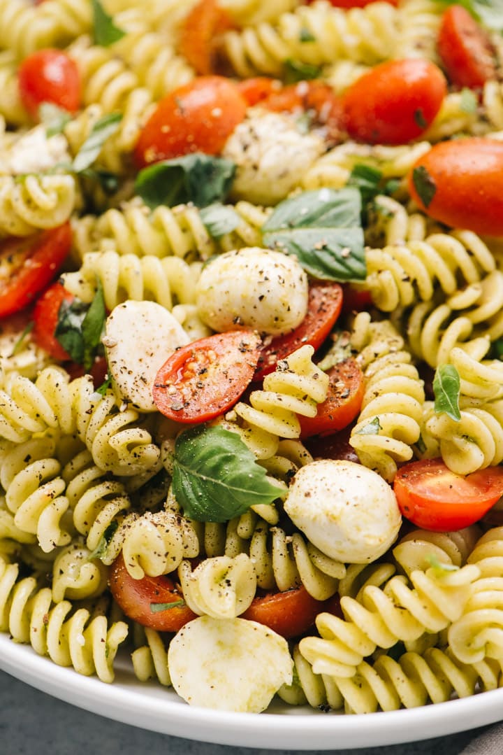 Side view, caprese pasta salad in a bowl.