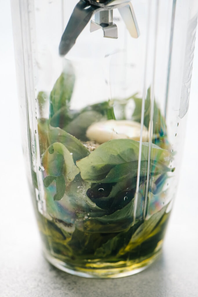 Basil and oil in a blender. 